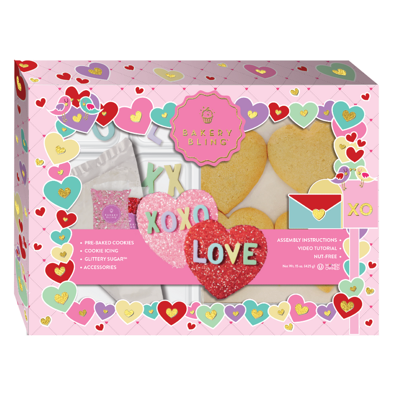 Bakery Bling Valentine's Day cookie decorating kit featuring heart-shaped pre-baked cookies, glittery sugar sprinkles, royal icing, and colorful edible letter decorations. Perfect for DIY Valentine’s activities, gifting, and holiday parties.